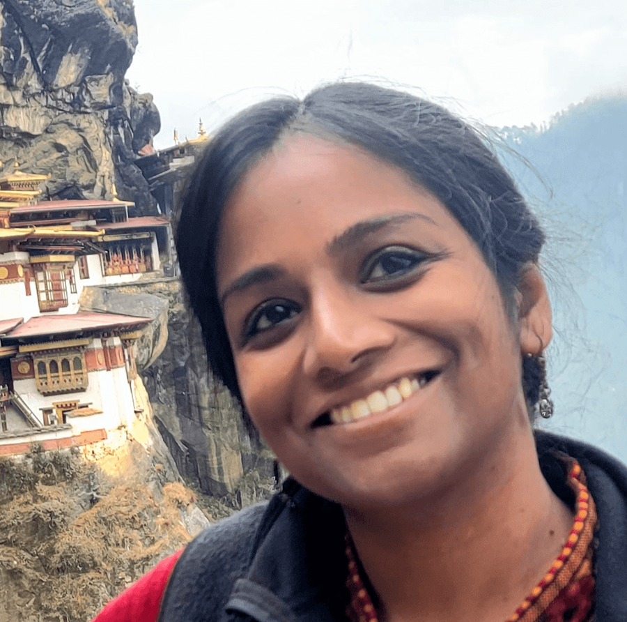 Sulagna (Dia) Ghosh smiling in front of a mountain vista