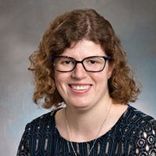 A headshot of smiling Caitlin Walsh, DLC Adminstrative Assistant