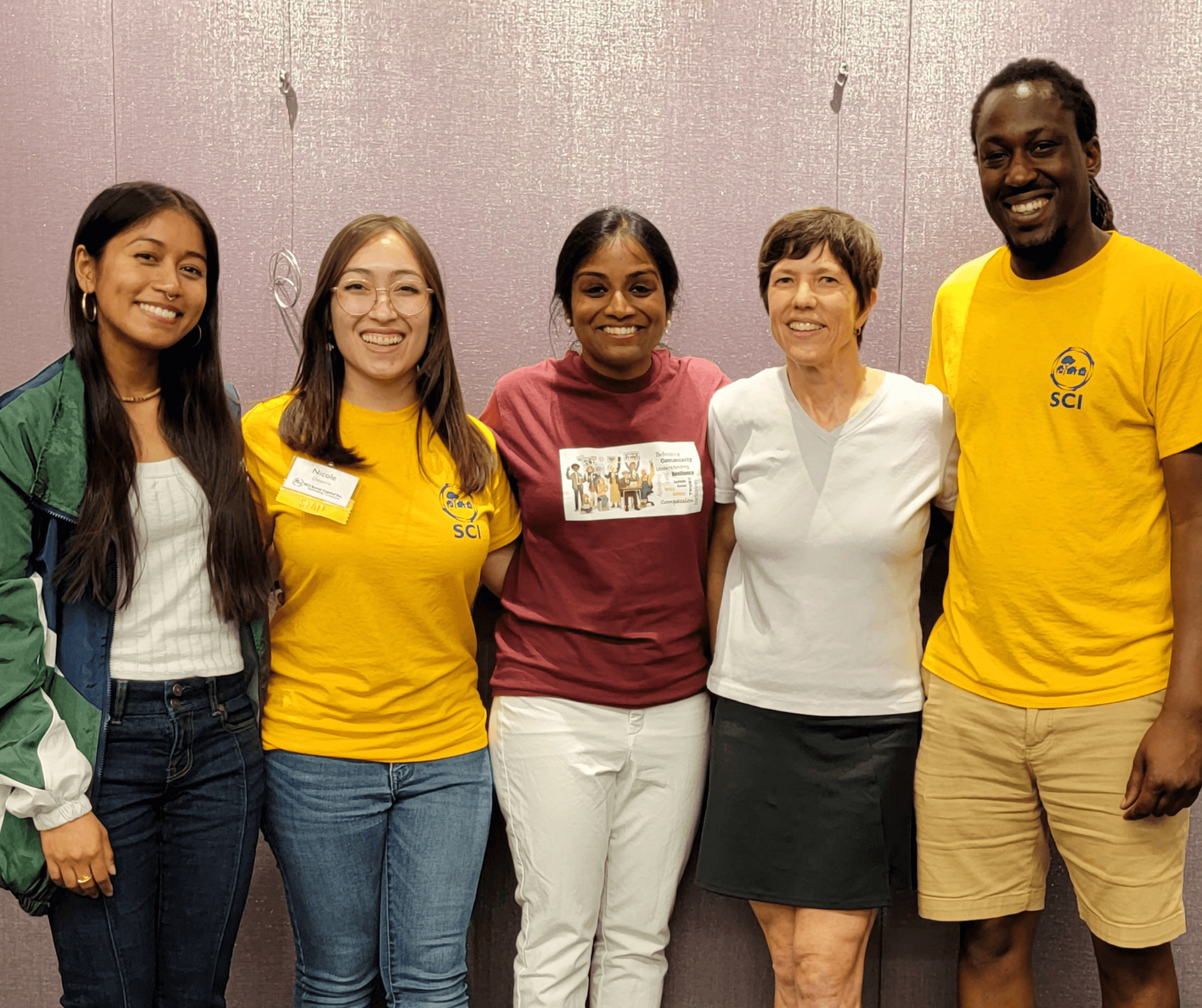 A group from Joint Family smiling with their arms around each other